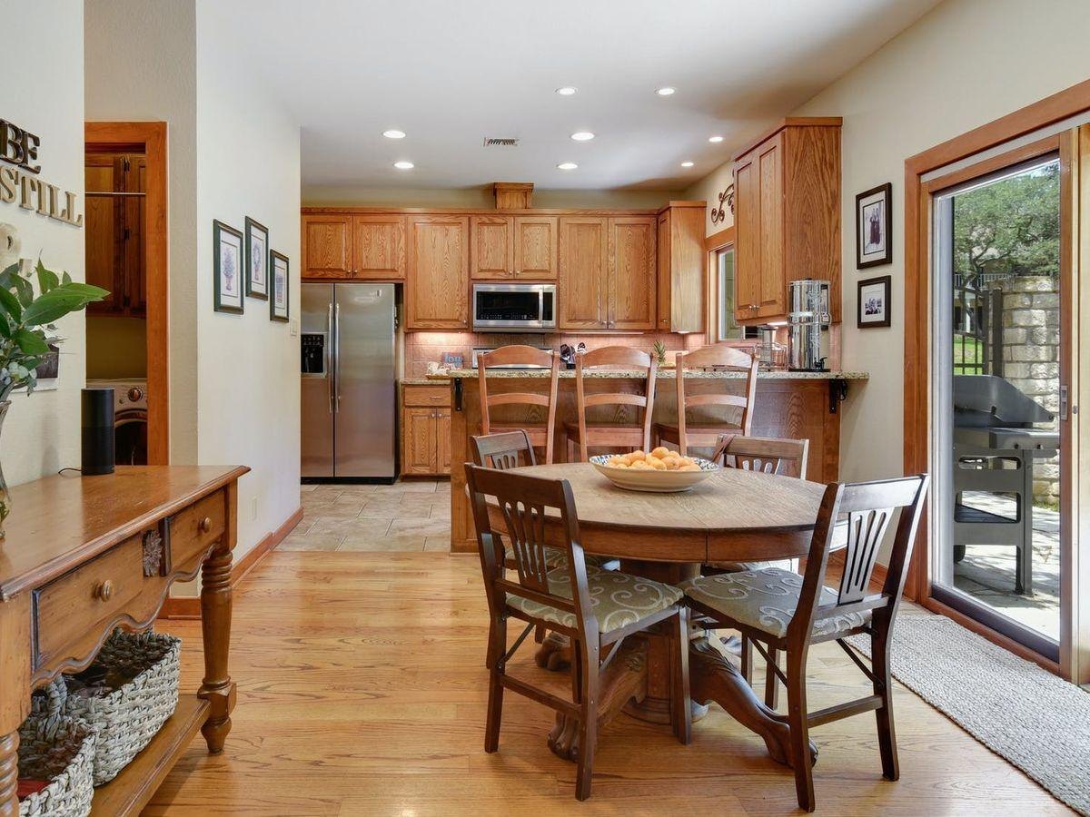 Before: a dining area with a round table and an oak kitchen behind it
