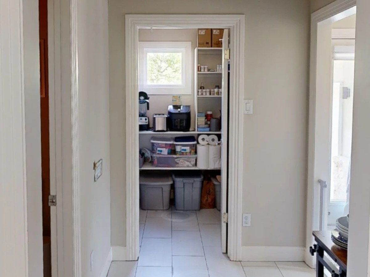 Before: a hall to a pantry of wire shelves and plastic bins