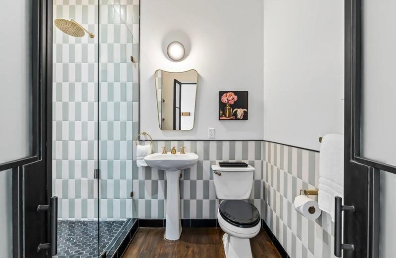 A bath with stacked tile and a pedestal sink