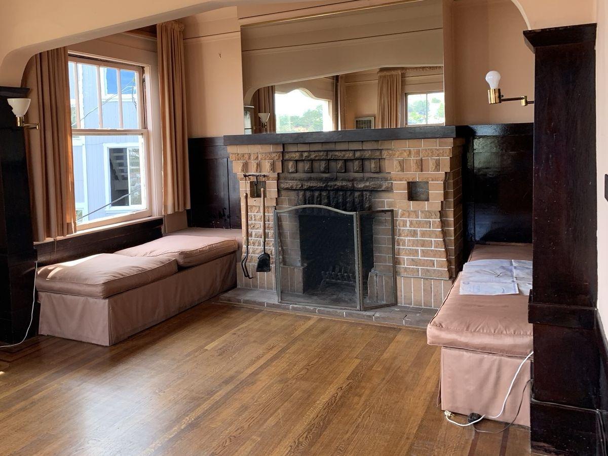 Before: a dark brick fireplace under an arch
