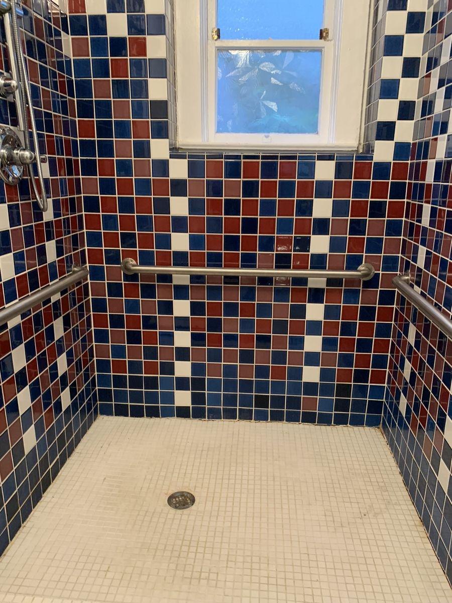 Before: a shower in blue and red checkerboard tile