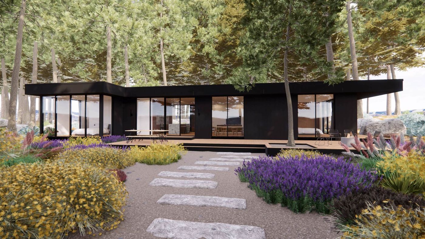 A low dark house behind a garden of lavender and stepping stones